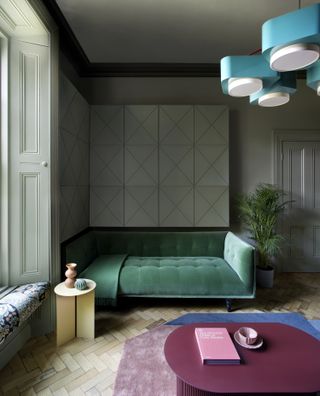 A living room with green sofa