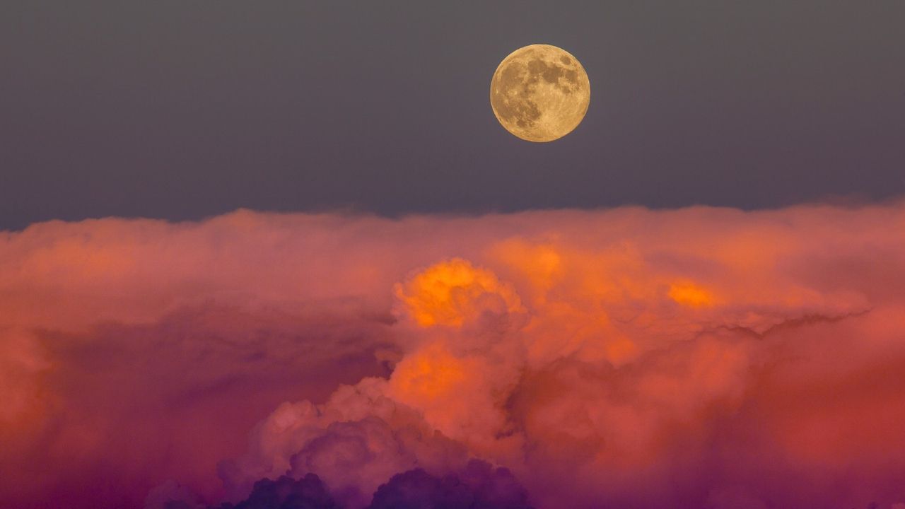 Harvest moon on the Autumn equinox. The moonrise just after it rose above a bank of storm clouds in southwestern Colorado near Hovenweep National Monument.