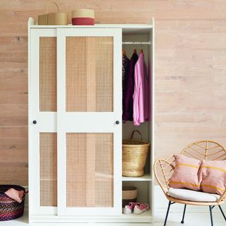 A cane-insert wardrobe with a chair to the side