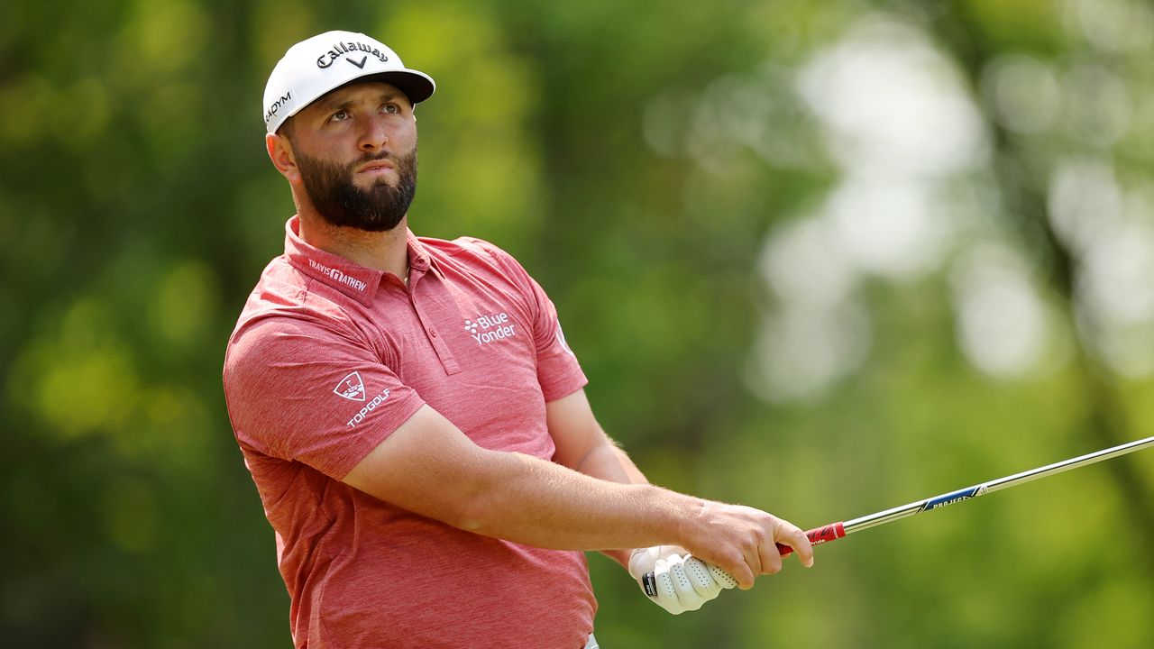 Jon Rahm plays an iron shot