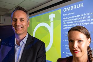 Kommunikasjonssjef Marte Ottemo og administrerende direktør Jan Røsholm i Stiftelsen Elektronikkbransjen poserer foran en slike om OmBrukt AS