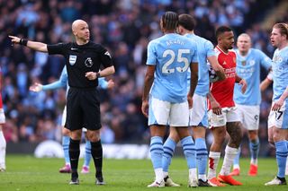 Players of Manchester City react towards Referee Anthony Taylor during the Premier League match between Manchester City and Arsenal FC at Etihad Stadium on March 31, 2024 in Manchester, England.(Photo by Robbie Jay Barratt - AMA/Getty Images)