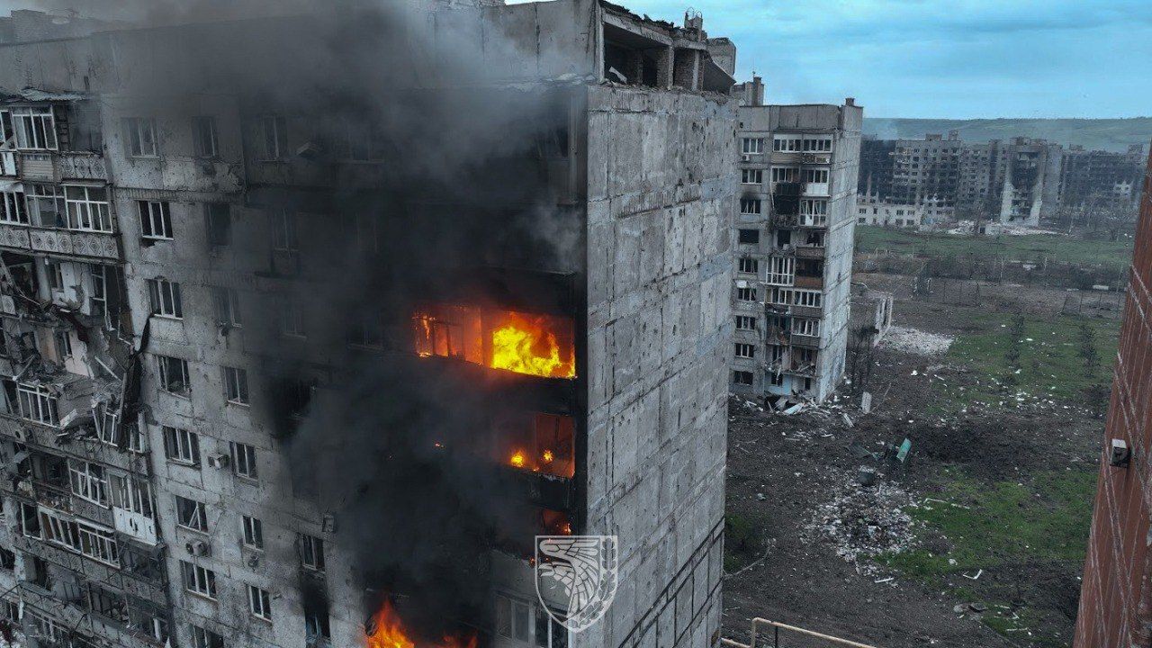 An aerial view of destroyed buildings on fire in Bakhmut