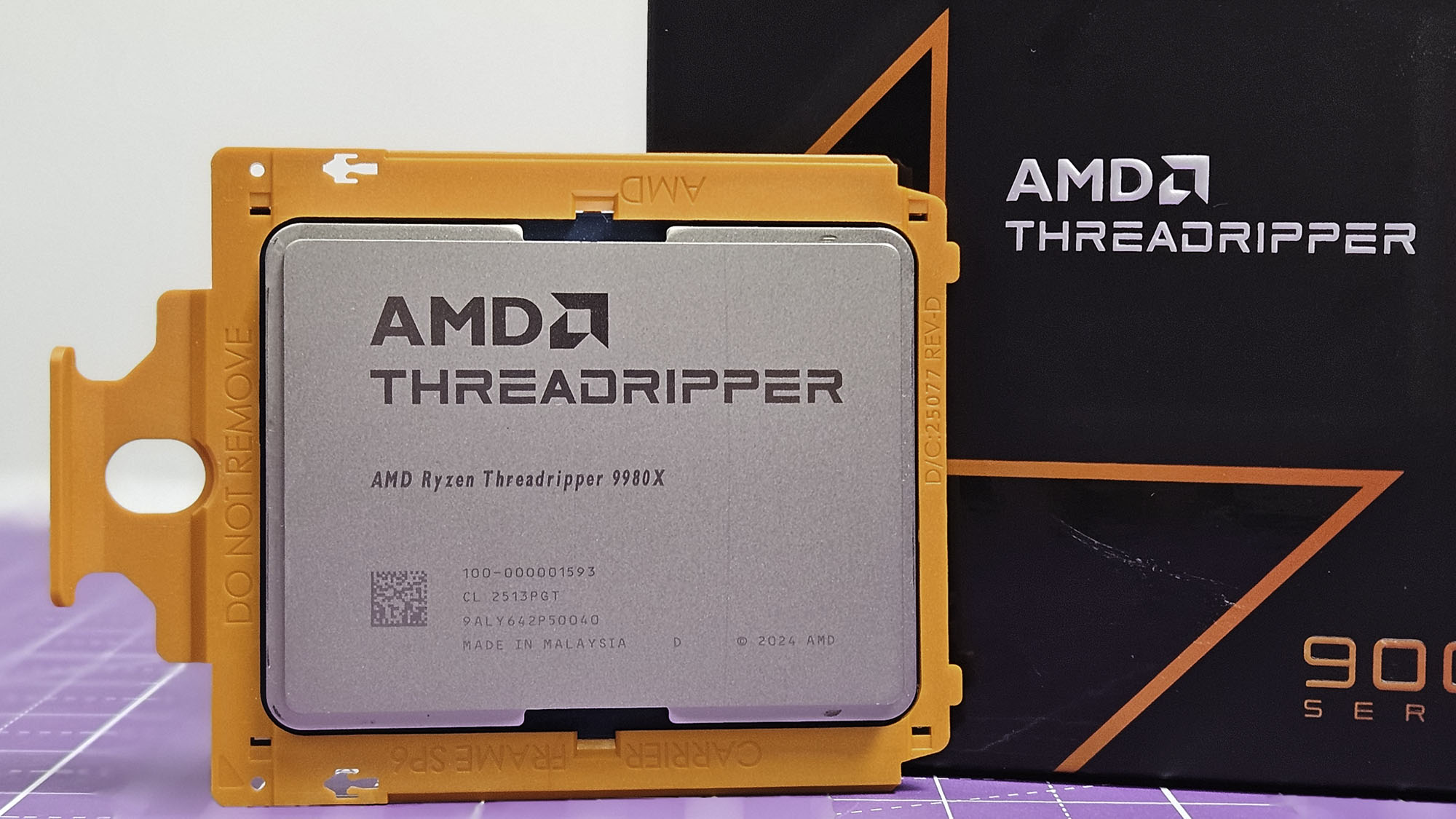 An AMD Ryzen Threadripper 9980X on a table with its retail packaging