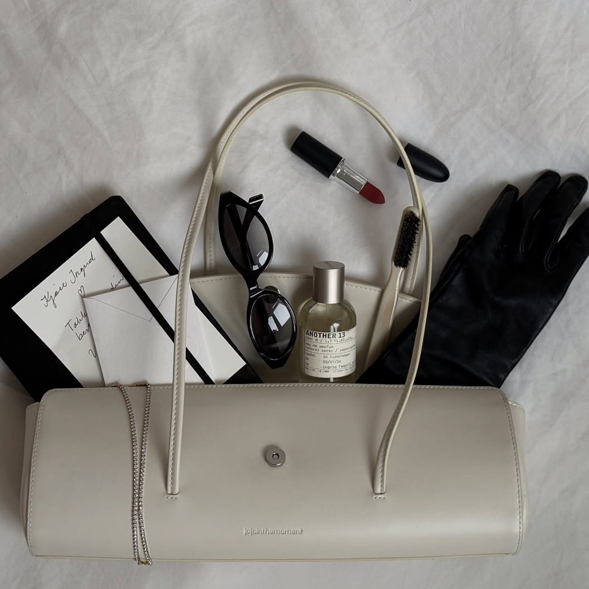 flatlay picture of handbag and beauty products