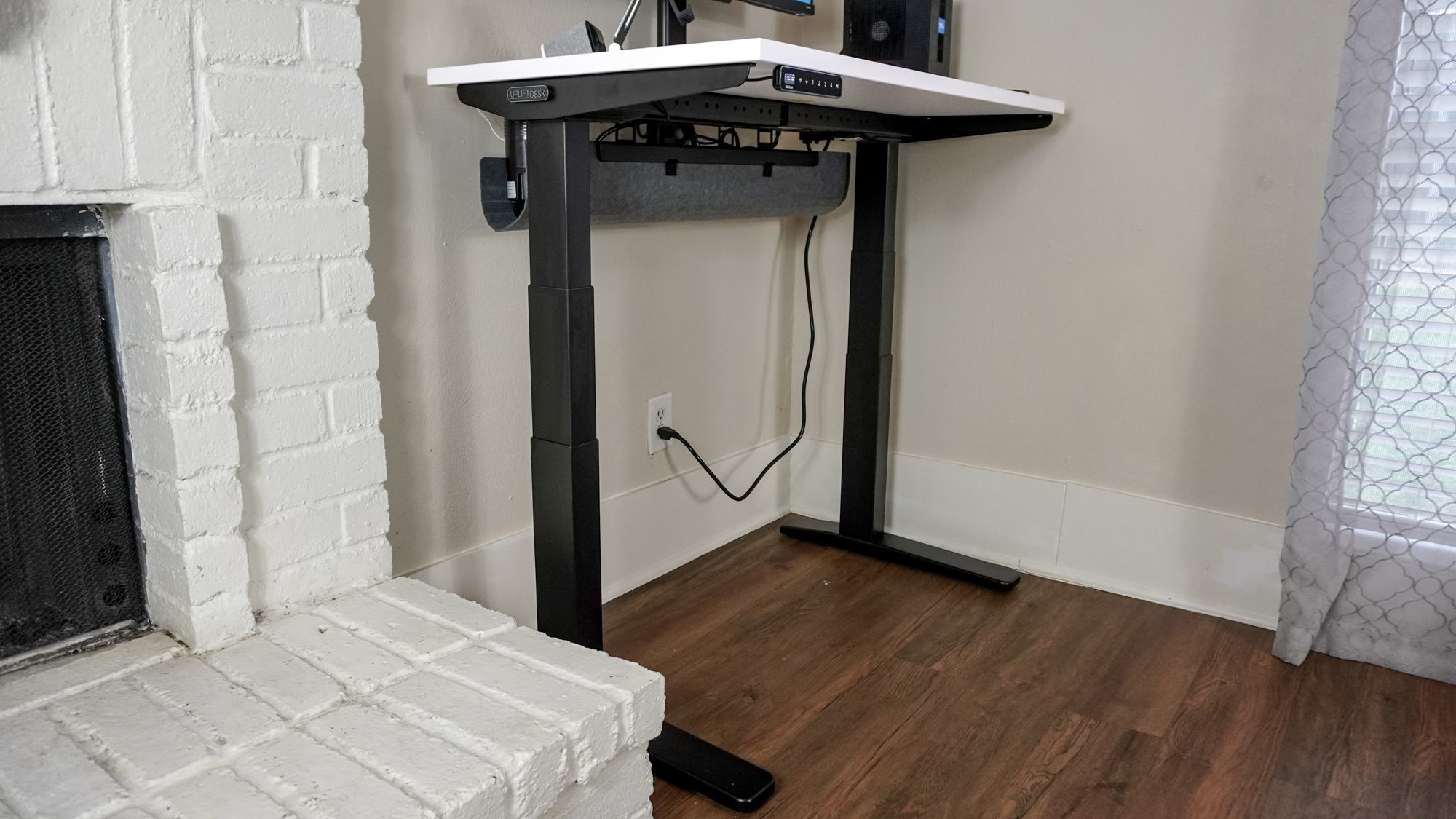 A side view of the Uplift V3 standing desk showing off its new, wider cable management tray