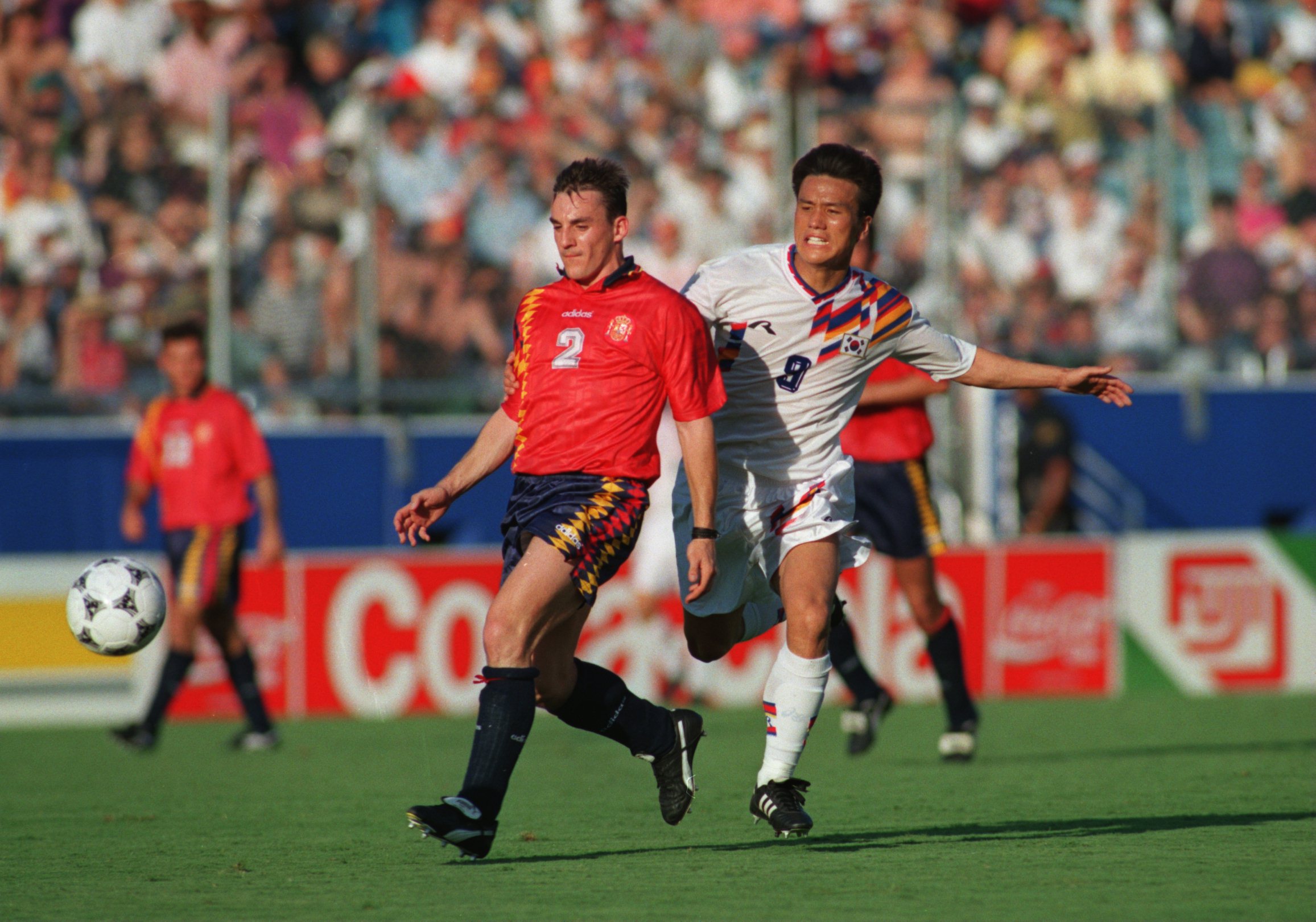 Spain's Albert Ferrer gets to the ball ahead of South Korea's Kim Joo-sung at the 1994 World Cup.