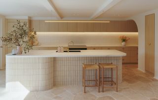 A kitchen with natural stone flooring, with counters in laminate