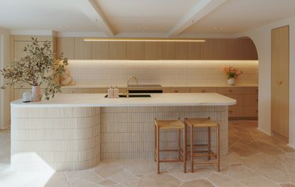 A kitchen with natural stone flooring, with counters in laminate 