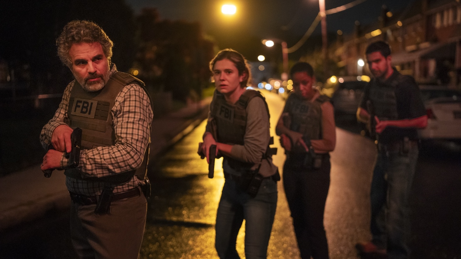Special Agent Tom Brandis (Mark Ruffalo) watchfully leads an armed task force through the dark Philadelphia streets in HBO crime drama Task.