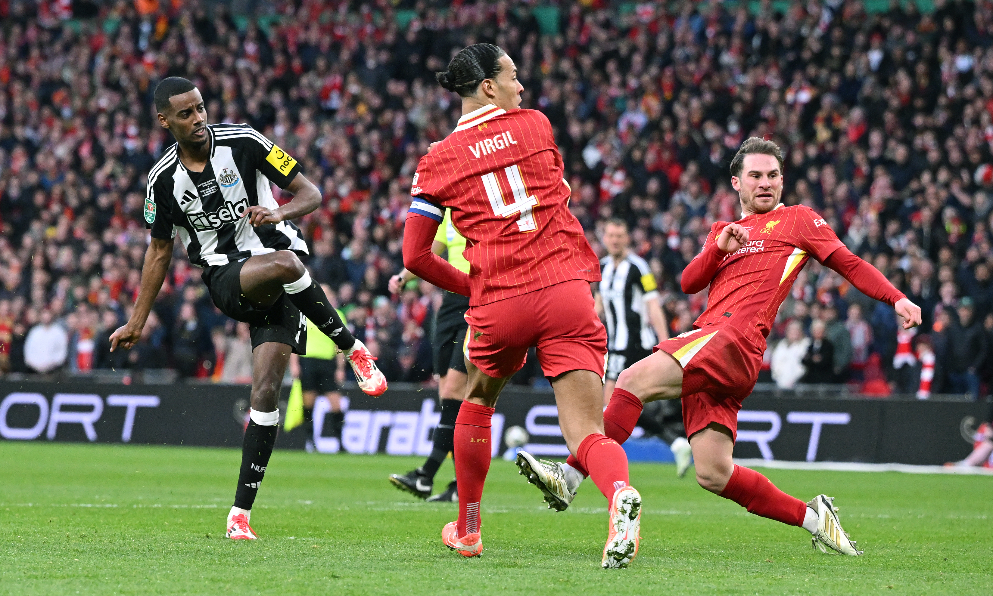 Alexander Isak scores past Virgil van Dijk in the Carabao Cup Final