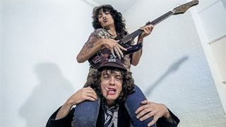 Bon Scott sitting on Angus Young's shoulders, August 1979