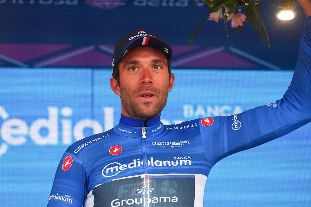 Groupama FDJs French rider Thibaut Pinot celebrates his best climber blue jersey on the podium after the fourth stage of the Giro dItalia 2023 cycling race 175 km between Venosa and Lago Laceno on May 9 2023 Photo by Luca Bettini AFP Photo by LUCA BETTINIAFP via Getty Images