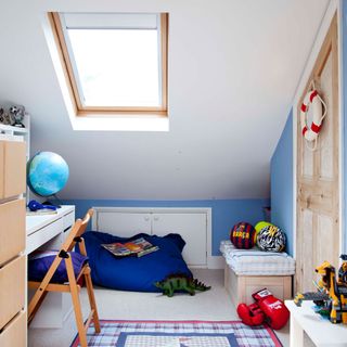 kids room with toys and sloped ceiling and rug