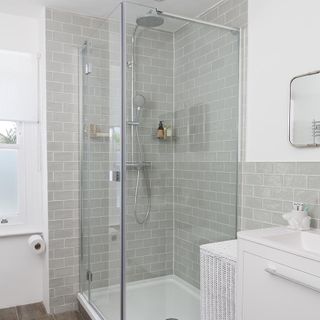 bathroom with white paint and grey tiles and shower area