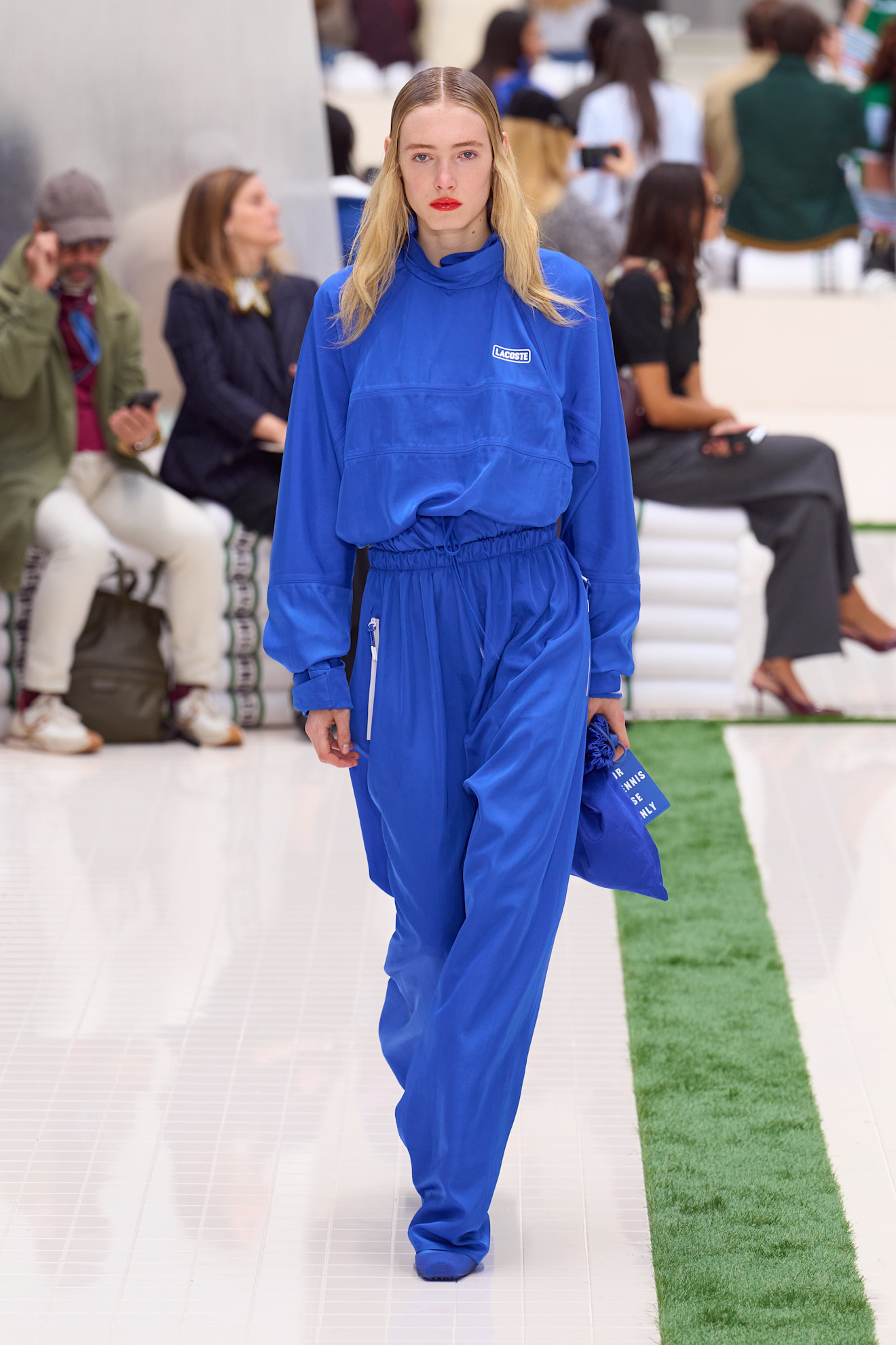 A model wore track pants in the Lacoste Spring 2026 fashion show