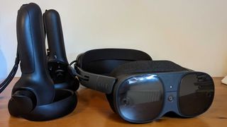 The Vive XR Elite and its controllers on a wooden table