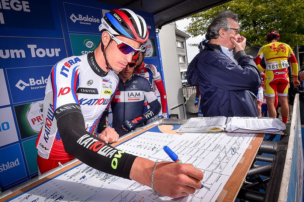 Riders sign in before the final stage in Belgium.