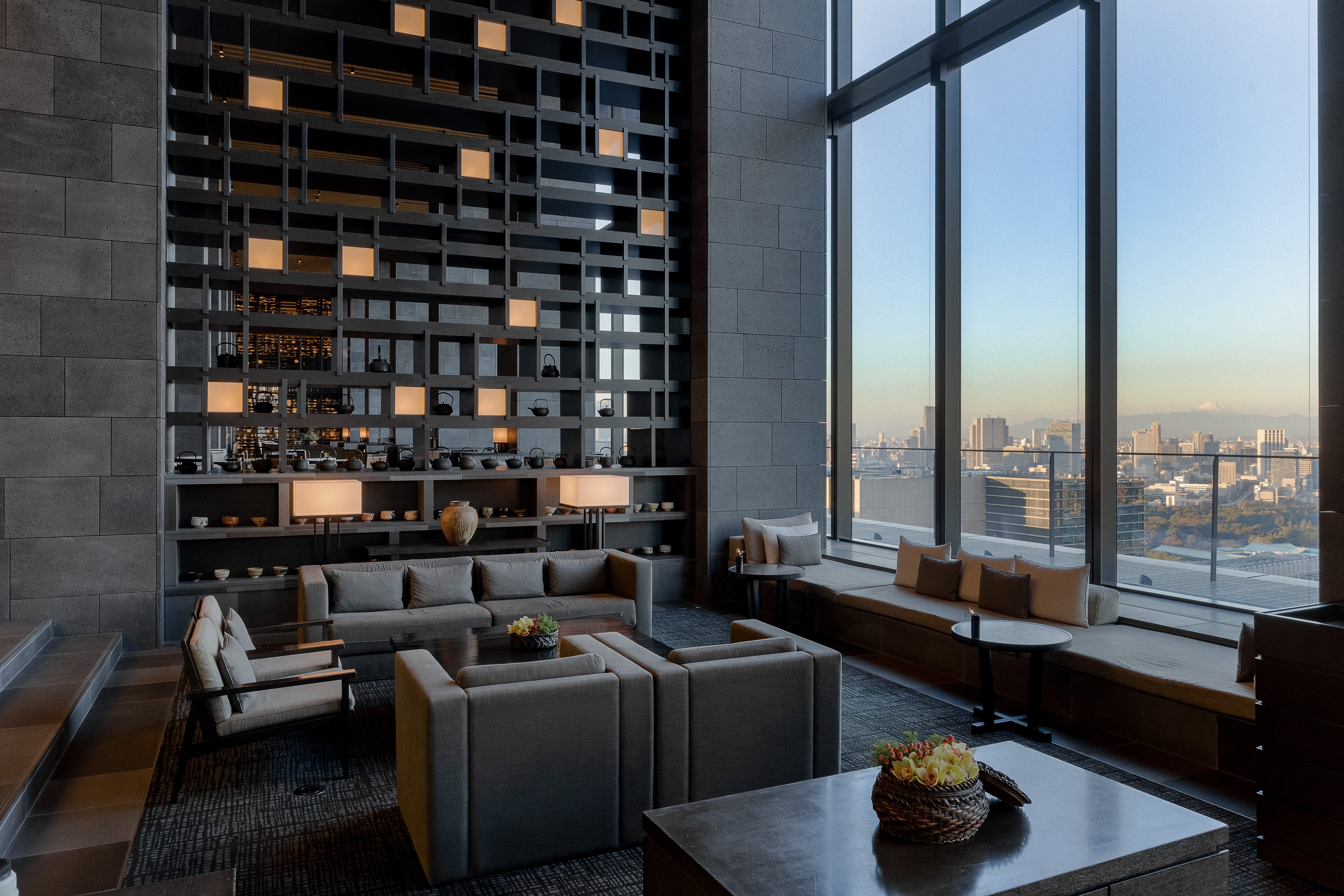 view of a serene hotel in tokyo, adorned with wooden furnishing, washi paper and natural stone touches
