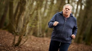 Elderly man running in wood