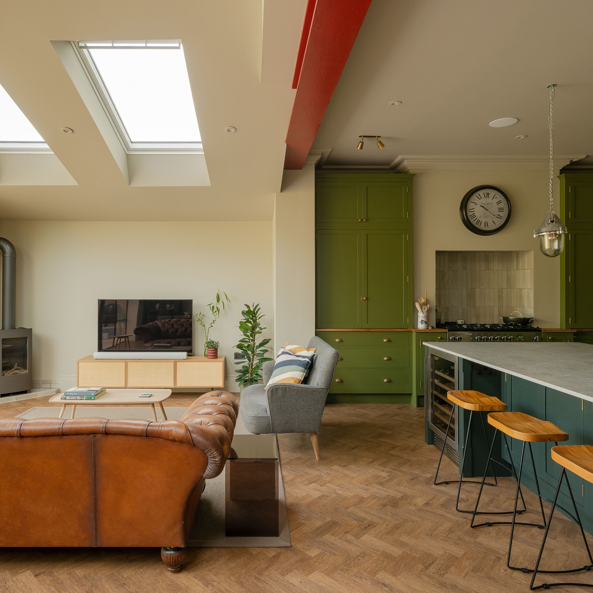 wooden parquet floor in open plan extended kitchen with zoned living room with brown and grey sofas