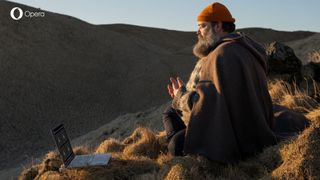 Opera's Tabfulness Guru Valgardur Hlöðversson meditates in a valley while sat in front of a laptop with the Opera Web Browser on screen.
