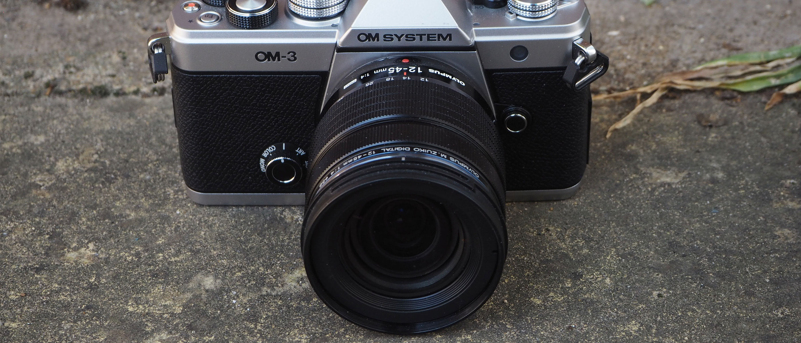 The OM System OM-3 on concrete ground.
