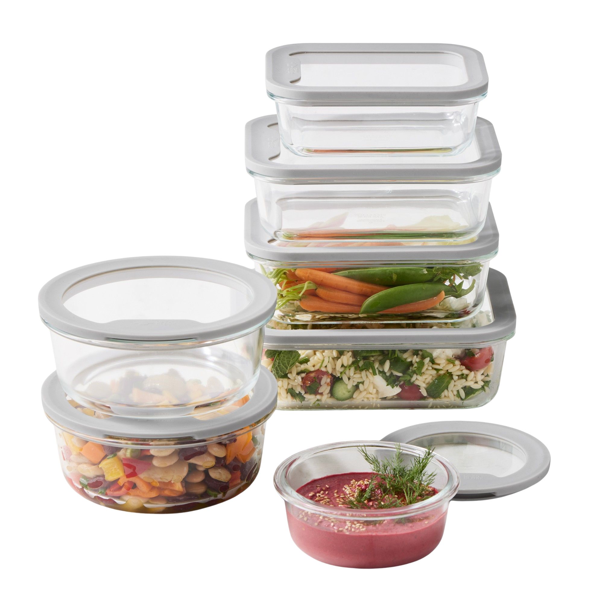 Glass food container set with glass lids. Some are round, some are rectangular, all but one are stacked like for like