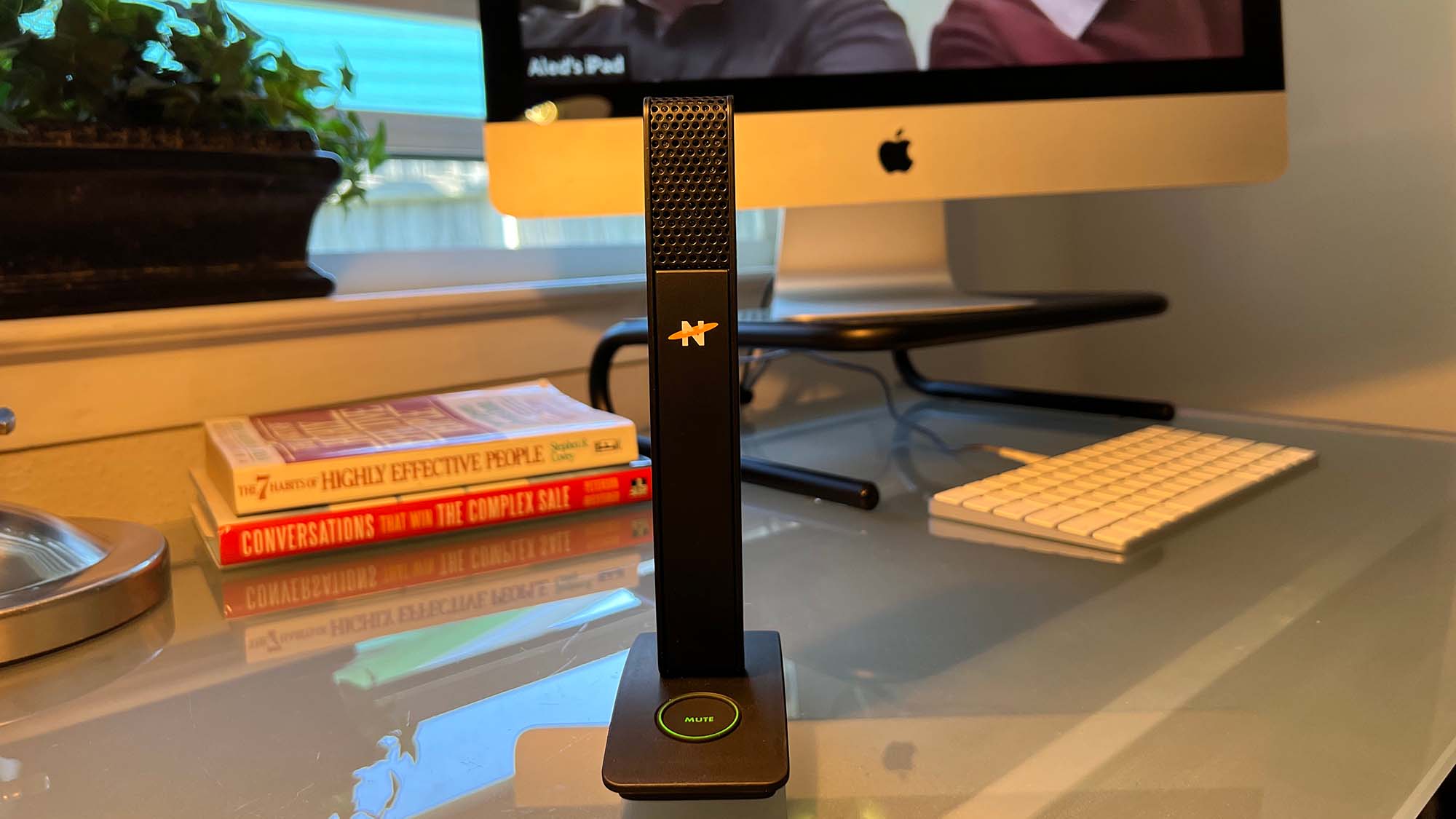 A Neat Skyline microphone on a desk during a conference call