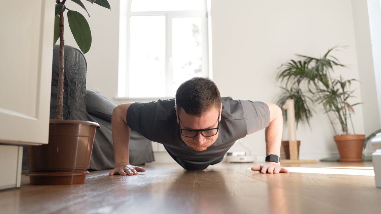 A man performing a push-up at home 