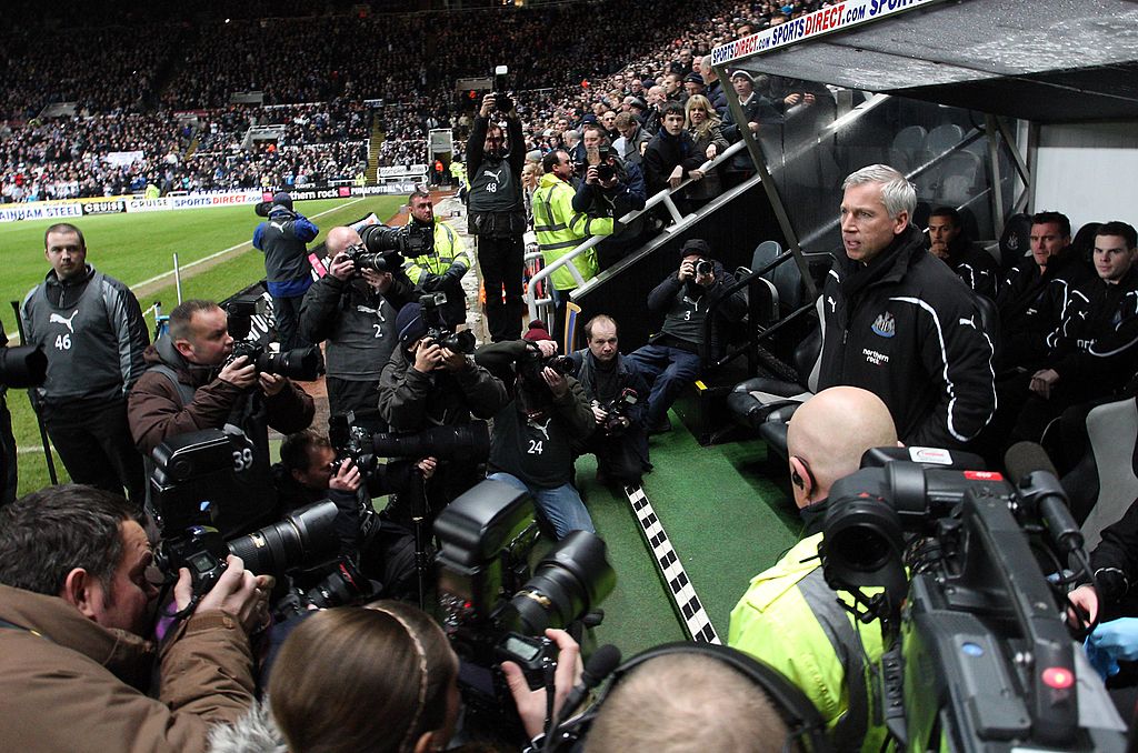 Alan Pardew surrounded by cameras in his first game in charge of Newcastle