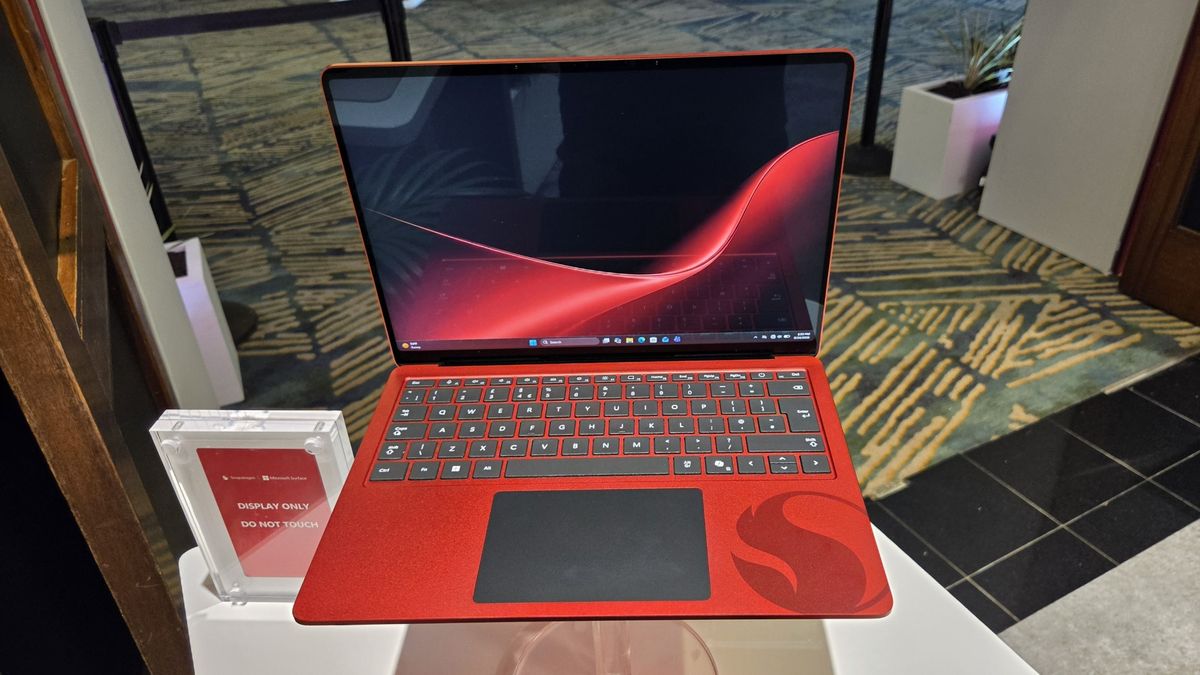 Microsoft Surface Laptop 13-inch 2nd Edition with Manchester United and Qualcomm Snapdragon branding on a red chassis, displayed with football imagery