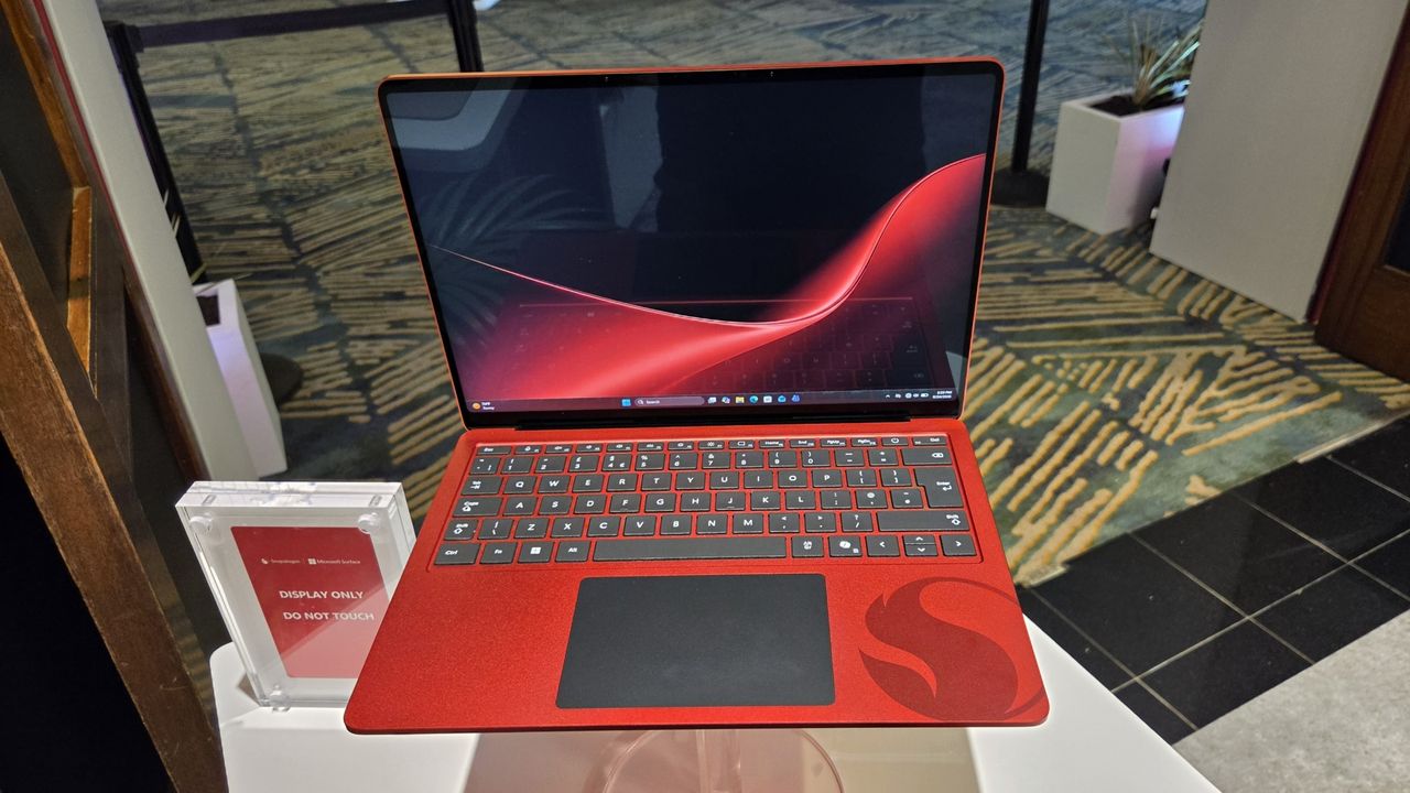 Microsoft Surface Laptop 13-inch 2nd Edition with Manchester United and Qualcomm Snapdragon branding on a red chassis, displayed with football imagery