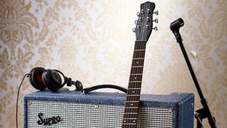 A pair of headphones on top of a guitar amp