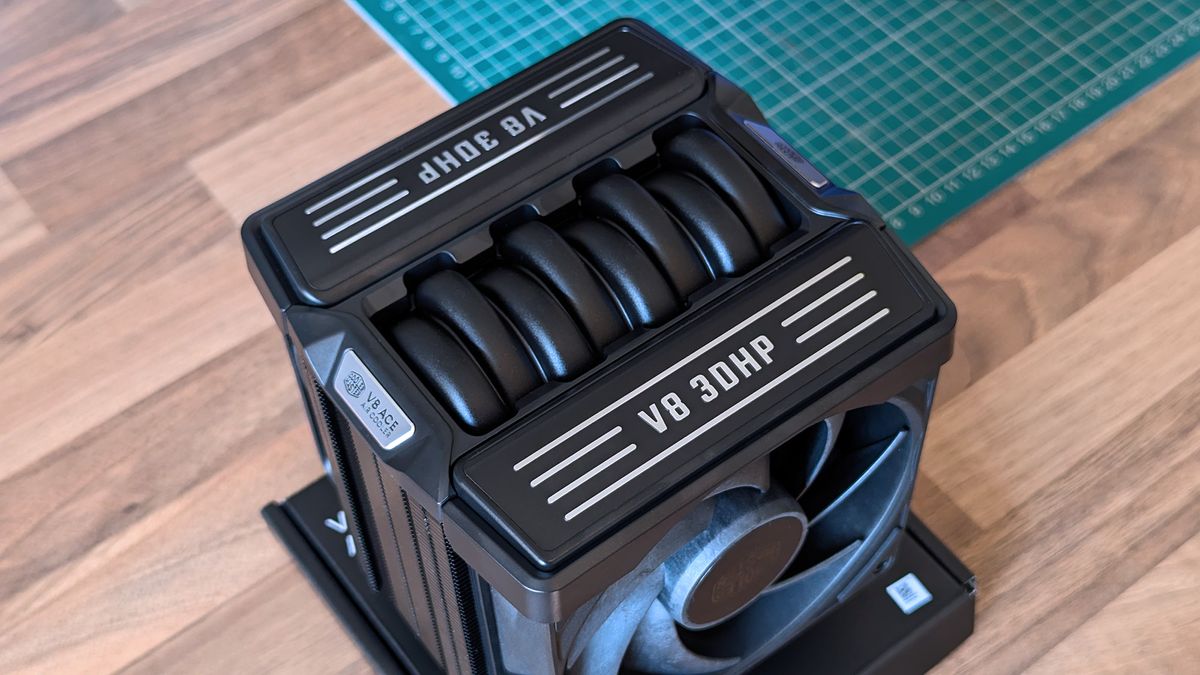 Close‑up of the Cooler Master V8 ACE 3DHP CPU cooler showing its engine‑inspired top shroud with &ldquo;V8 3DHP&rdquo; and &ldquo;V8 ACE Air Cooler&rdquo; branding.