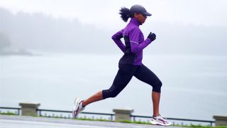 Woman running along waterfront path