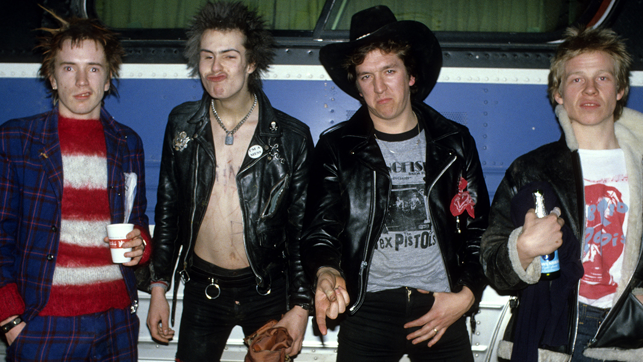 Sex Pistols Johnny Rotten, Sid Vicious, Steve Jones and Paul Cook posed, group shot by the tourbus on final tour.