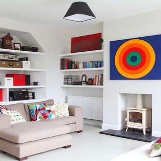 living area with white wall and fireplace and sofa with shelves