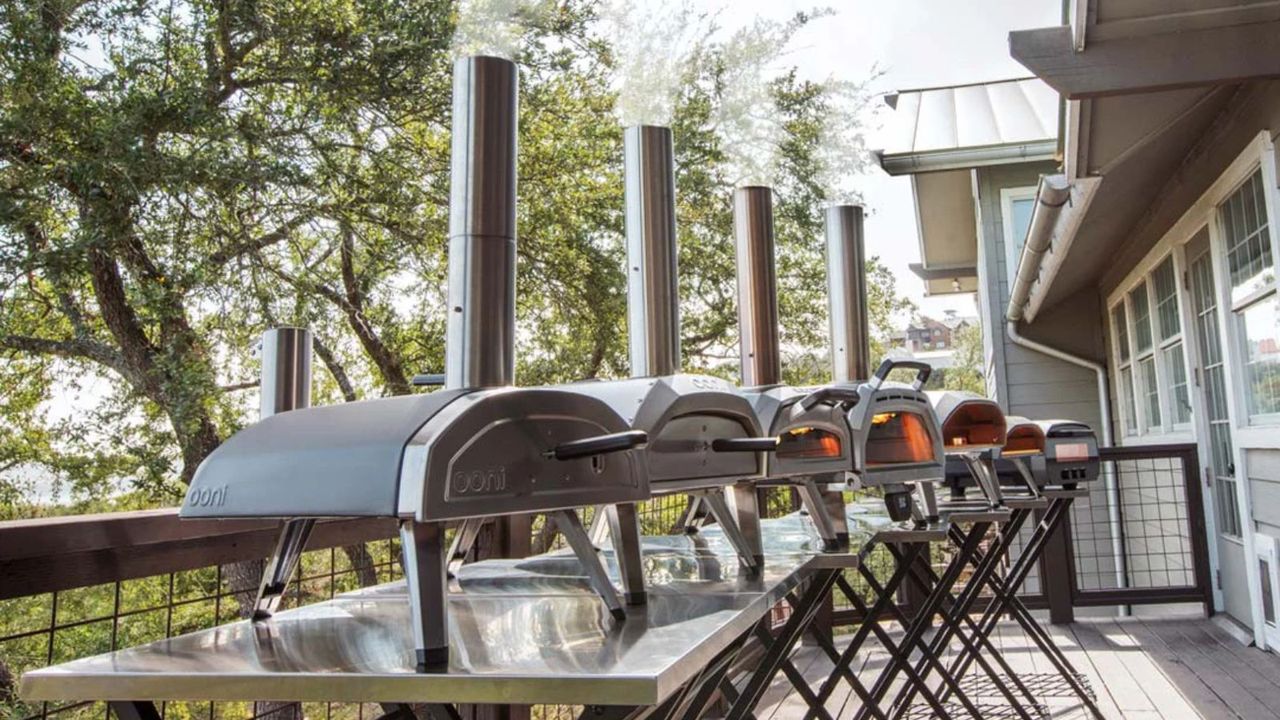 A line of Ooni pizza ovens on a balcony