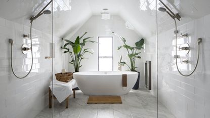 White bathroom with double showers and freestanding bath