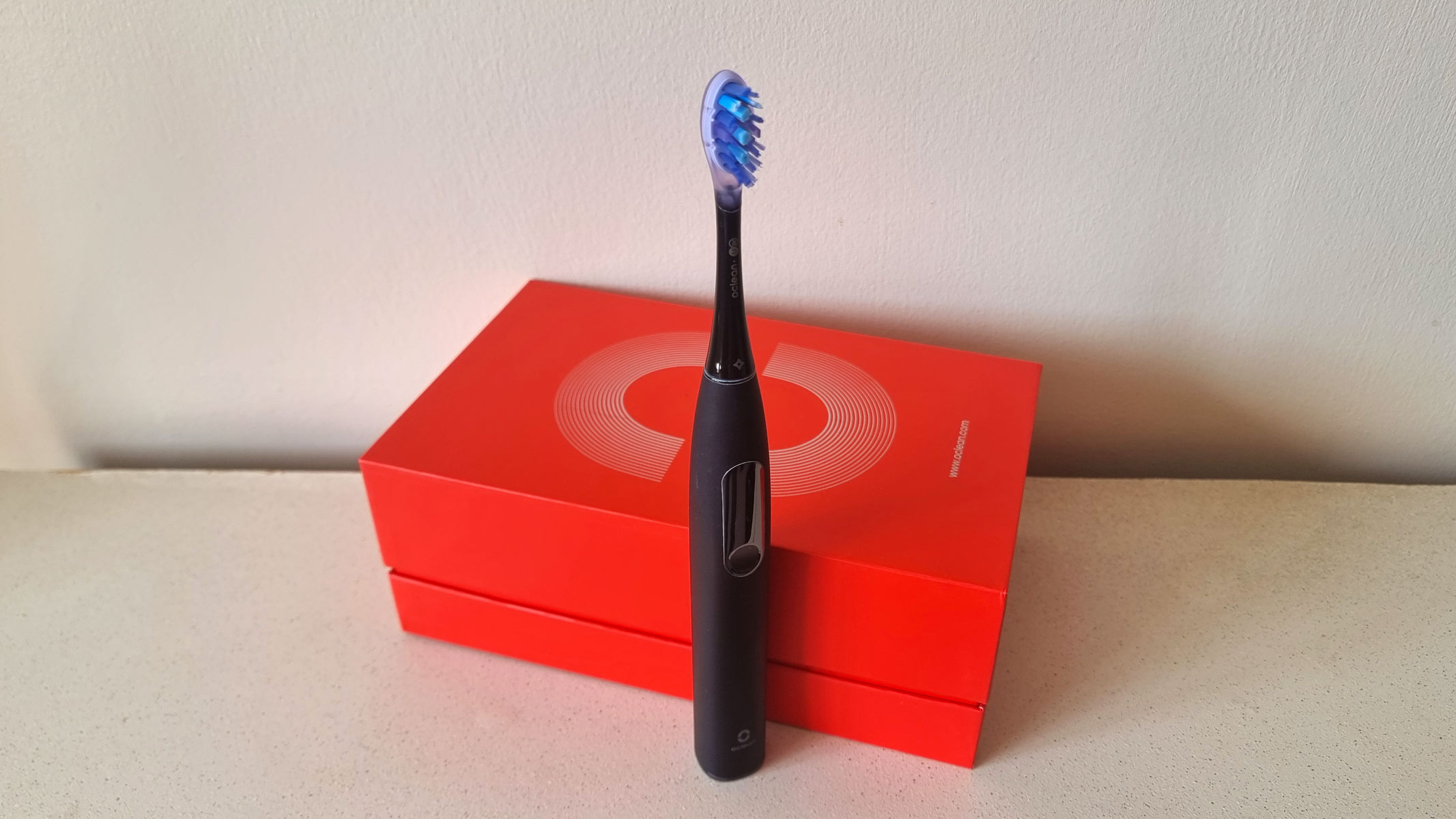 Oclean X Ultra S electric toothbrush standing in front of the box
