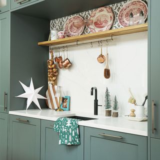 Christmas kitchen with green cabinets and sink