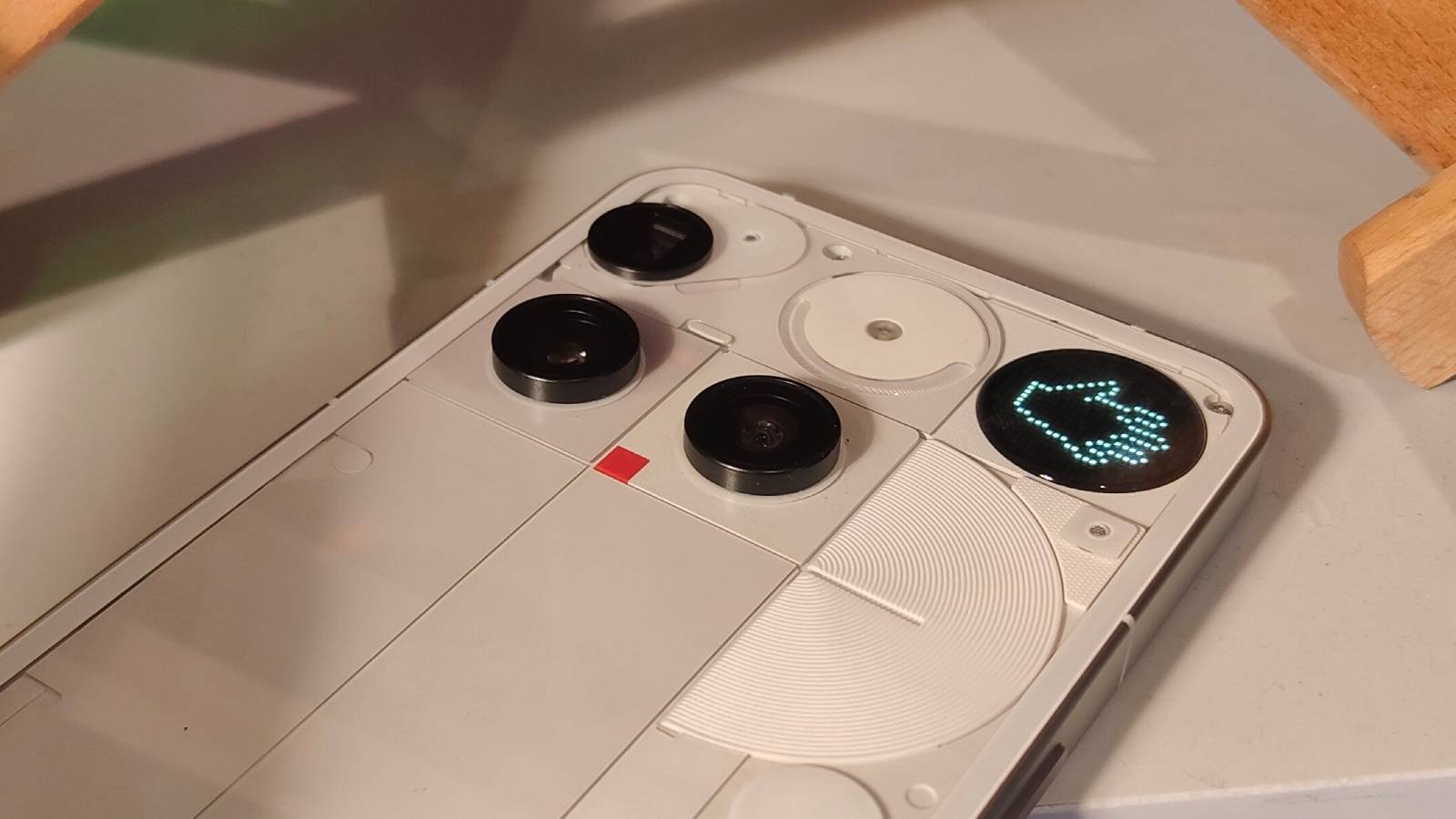 The Nothing Phone 3 laid down, showing its rear cameras and Glyph matrix.