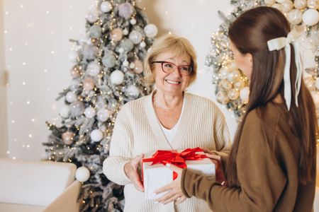 Joyful Holiday Gift Exchange Between Grandmother and Granddaughter 
