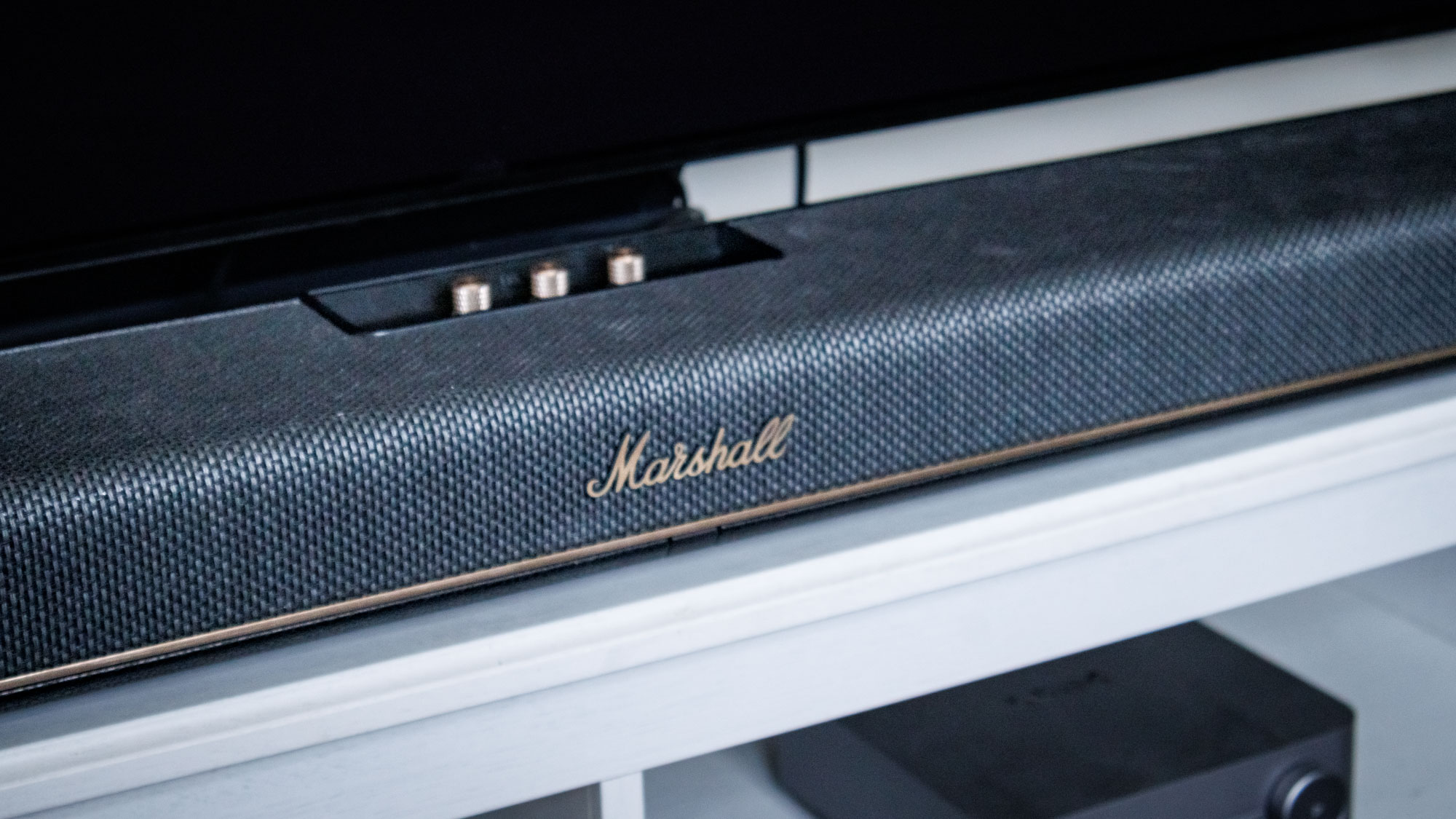 A Marshall Heston 120 soundbar on a TV stand.