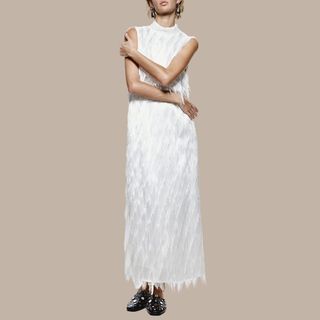 flat lay image of a white fringed dress