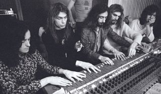 The members of Yes sit at the mixing board