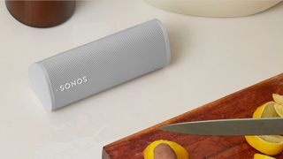 best smart speaker: Sonos Roam on kitchen top next to person cutting lemon wedges