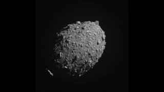 a gray rocky ball against black space