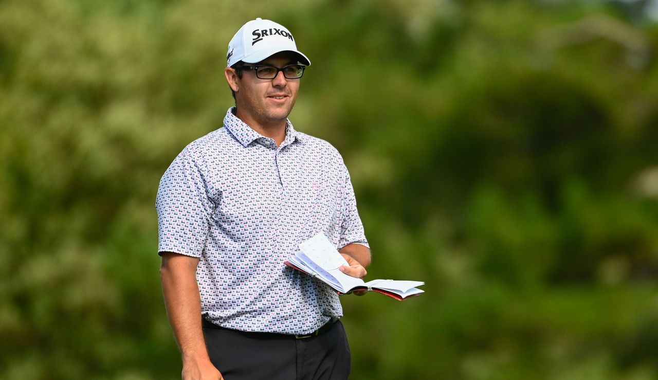 Matt Atkins smiles on whilst holding a yardage book